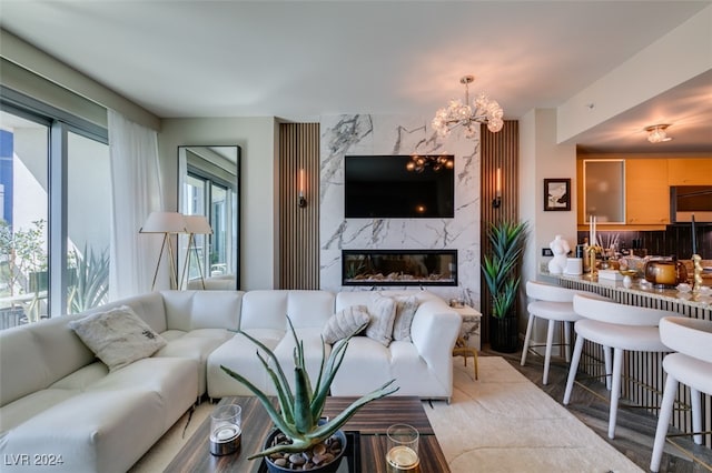 living room with a premium fireplace and a chandelier