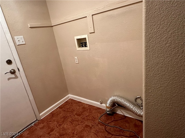 washroom with hookup for a gas dryer, dark tile patterned floors, and washer hookup