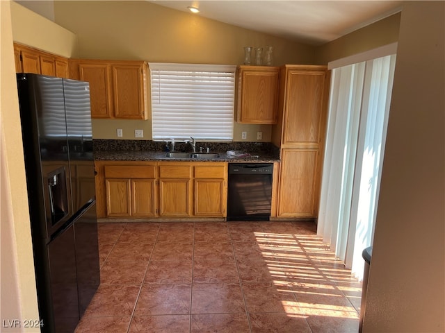 kitchen with tile patterned floors, black dishwasher, sink, vaulted ceiling, and fridge with ice dispenser