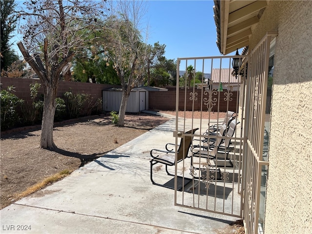 view of patio featuring a storage shed