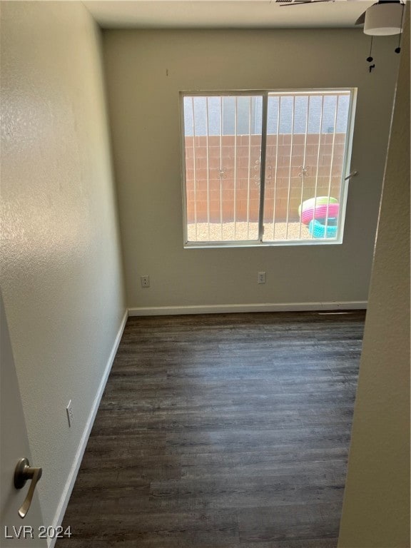 empty room featuring dark hardwood / wood-style floors and a healthy amount of sunlight