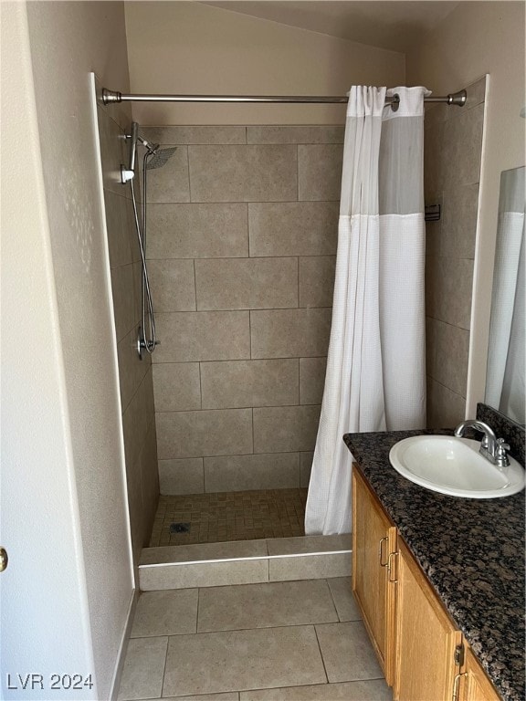 bathroom featuring vanity, a shower with shower curtain, and tile patterned flooring