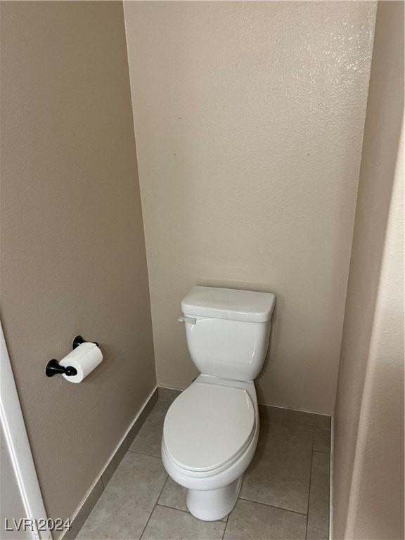 bathroom featuring toilet and tile patterned floors