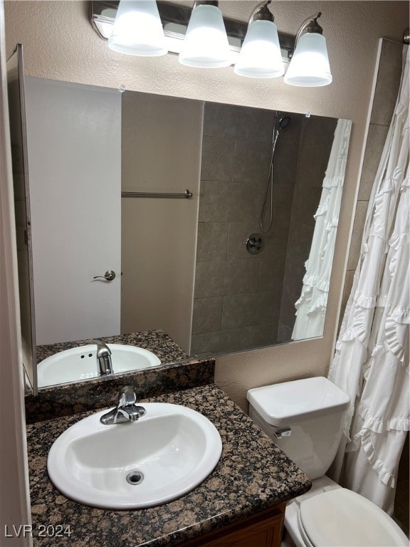 bathroom with vanity, a shower with shower curtain, and toilet