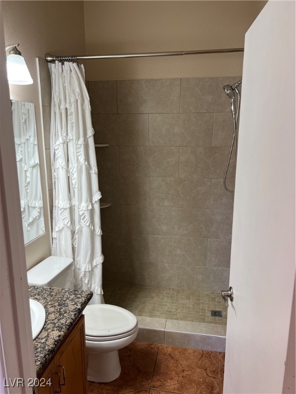 bathroom with vanity, curtained shower, toilet, and tile patterned flooring