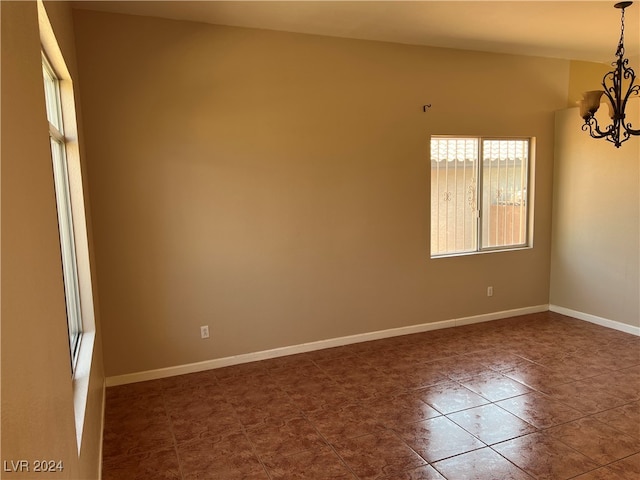 empty room featuring an inviting chandelier