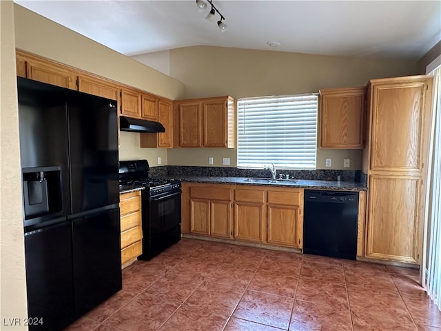 kitchen featuring black appliances, sink, tile patterned floors, lofted ceiling, and track lighting