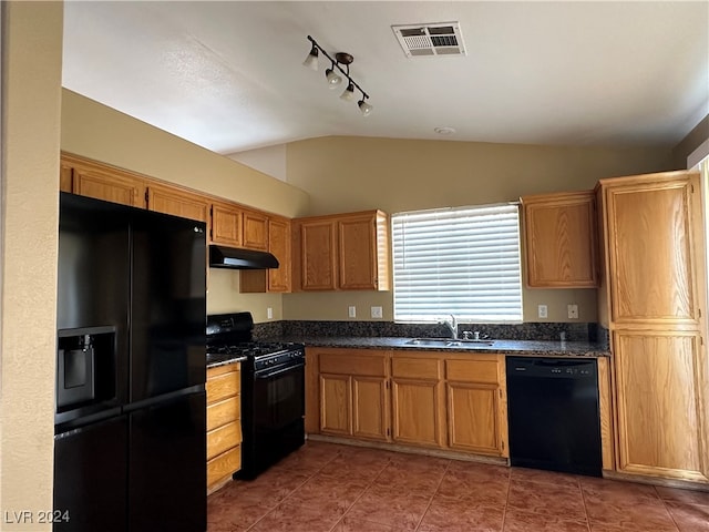 kitchen with black appliances, sink, dark tile patterned floors, rail lighting, and lofted ceiling