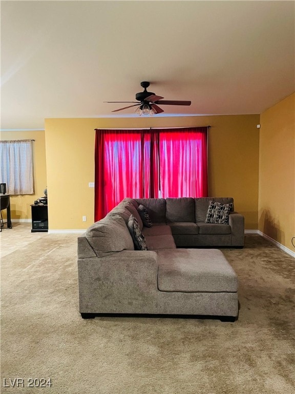 carpeted living room featuring ceiling fan