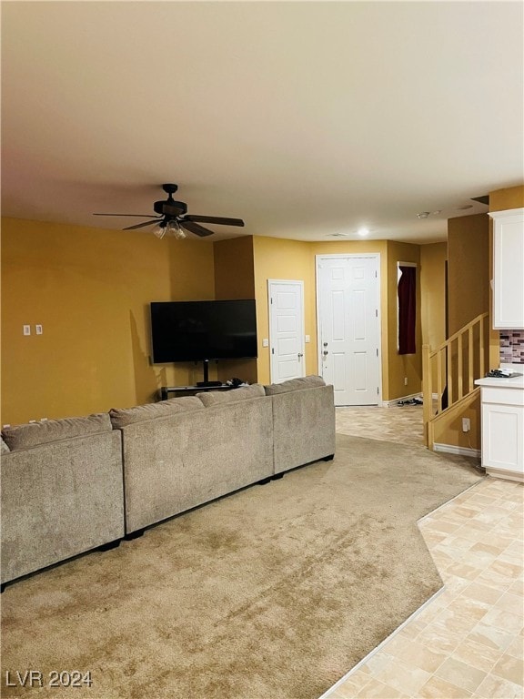 living room featuring light colored carpet and ceiling fan