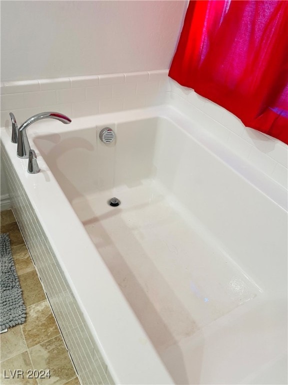 bathroom with tiled tub