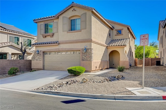 mediterranean / spanish house with central AC and a garage