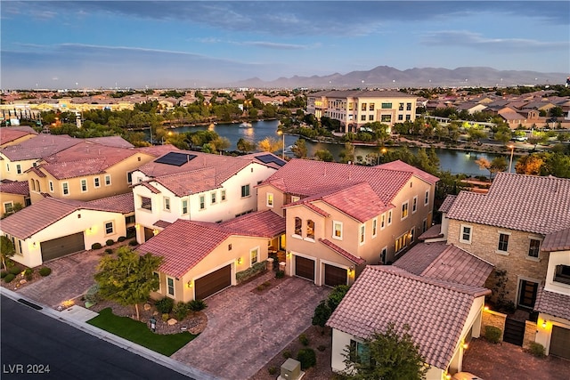 aerial view featuring a water and mountain view