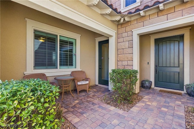 entrance to property with a patio area