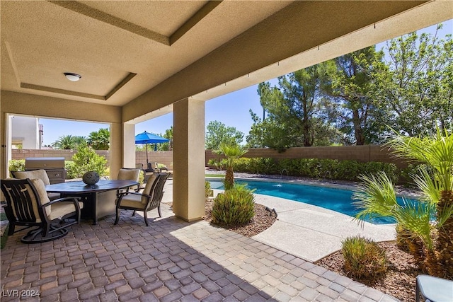 view of patio with a grill and a fenced in pool