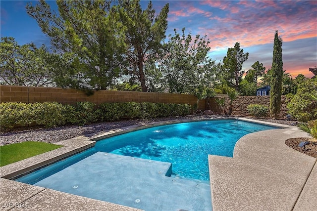 view of pool at dusk