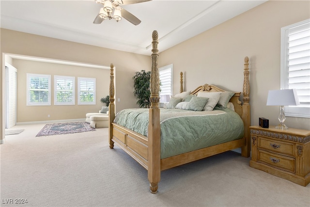 carpeted bedroom with ceiling fan and multiple windows