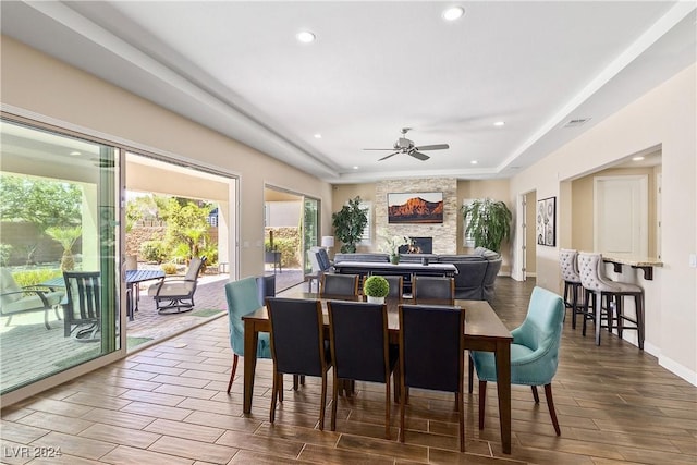 dining room with ceiling fan and a tray ceiling