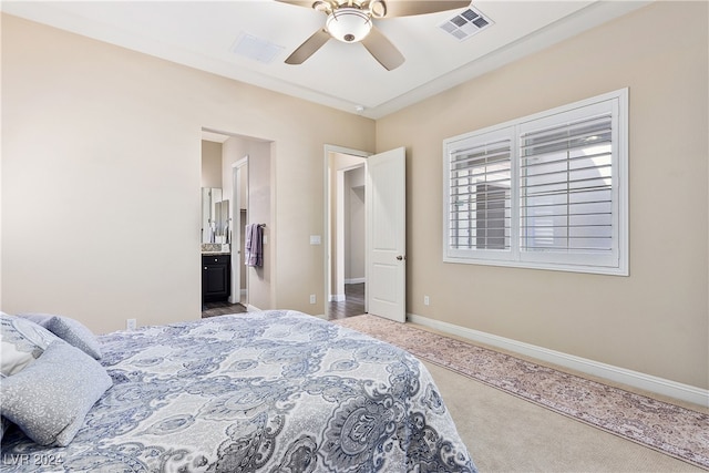 bedroom featuring ceiling fan, ensuite bathroom, and carpet floors