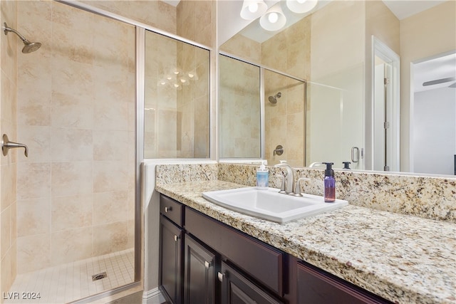 bathroom with an enclosed shower and vanity