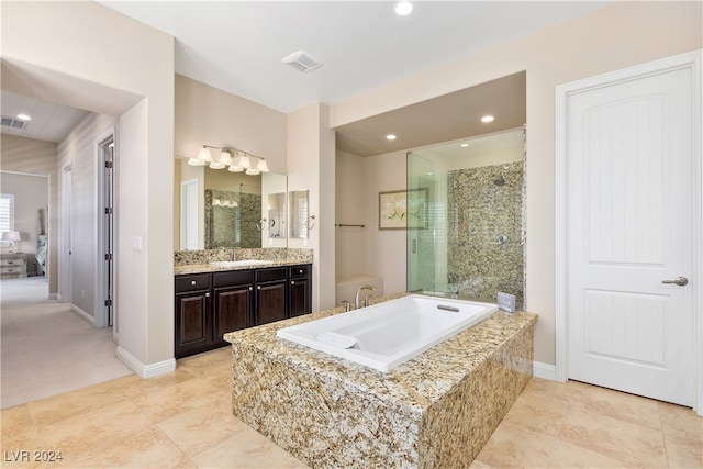 bathroom featuring vanity and shower with separate bathtub