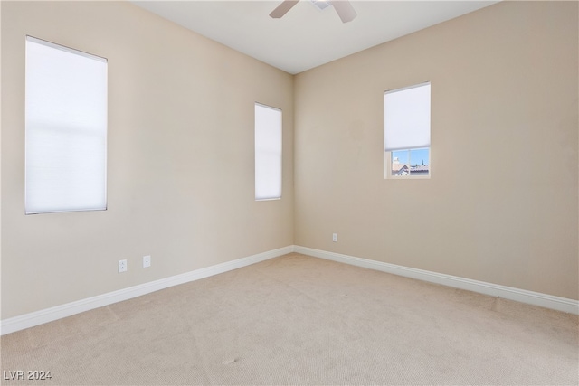 unfurnished room with light carpet and ceiling fan