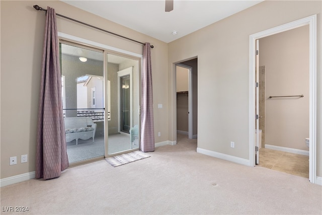 unfurnished bedroom featuring ceiling fan, a closet, and light carpet