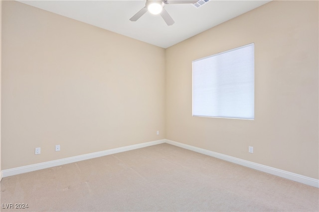 empty room with ceiling fan and light colored carpet