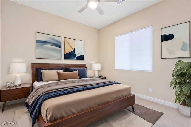 bedroom featuring ceiling fan and light colored carpet