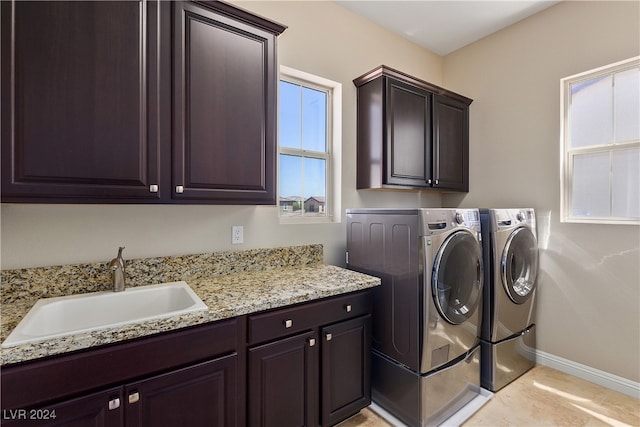 laundry area with sink, cabinets, and washer and dryer