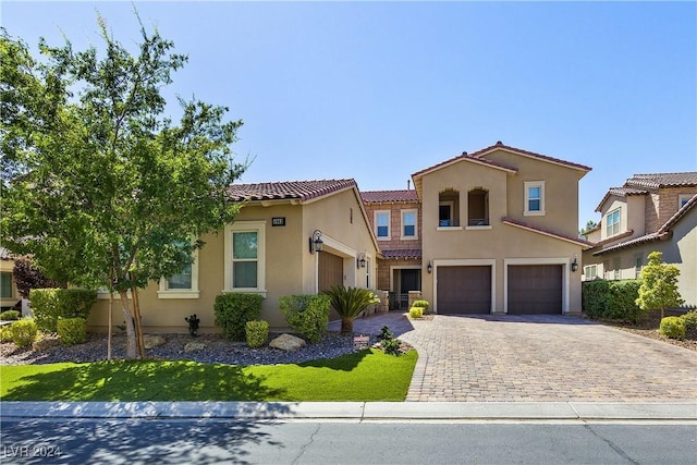 mediterranean / spanish home featuring a garage