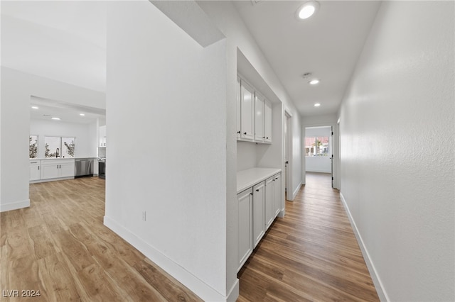 hall with sink and light hardwood / wood-style floors