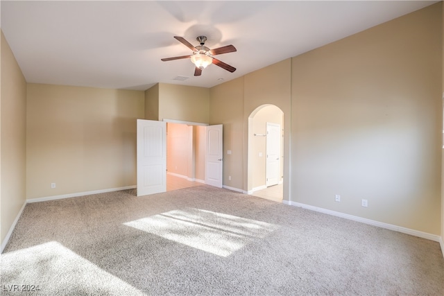 empty room featuring light carpet and ceiling fan