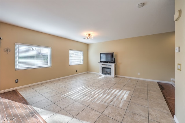 unfurnished living room with light tile patterned floors