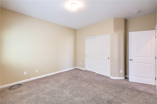 unfurnished bedroom featuring a closet and carpet floors