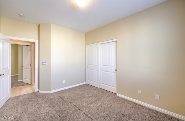 unfurnished bedroom with a closet and carpet