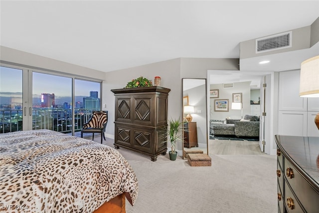 3111 Bel Air Dr Unit 25A, Las Vegas, NV 89109 - bedroom with access to exterior, light colored carpet, a view of city, and baseboards