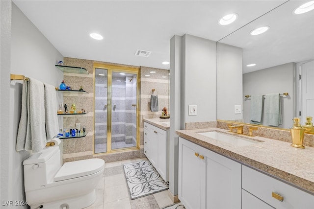 bathroom featuring toilet, tile patterned flooring, vanity, and a shower with door