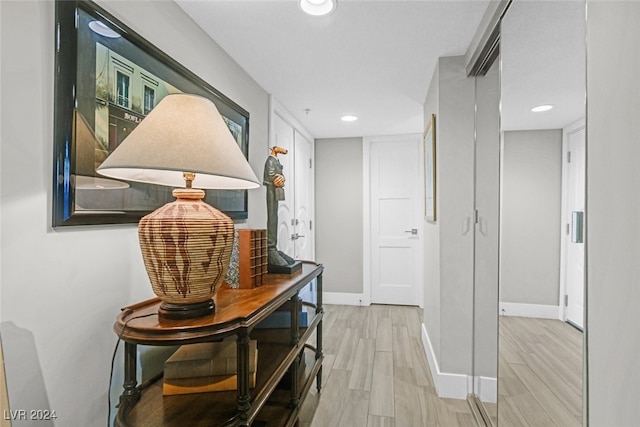 corridor with light hardwood / wood-style flooring