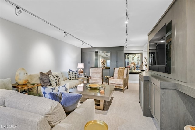 living room with light colored carpet and track lighting