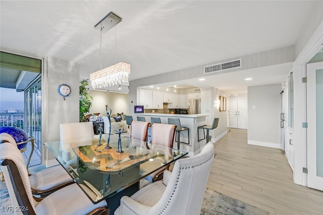 dining space with light hardwood / wood-style floors