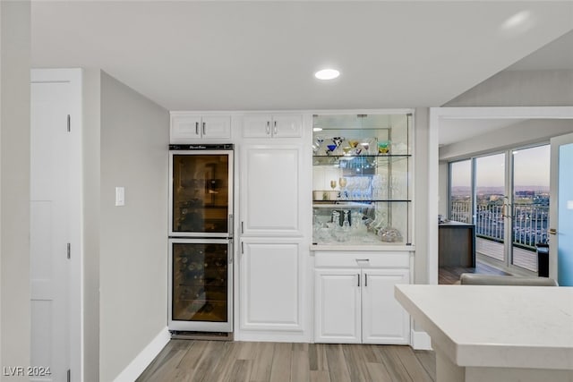 3111 Bel Air Dr Unit 25A, Las Vegas, NV 89109 - bar area featuring wine cooler, light wood-style flooring, baseboards, and recessed lighting