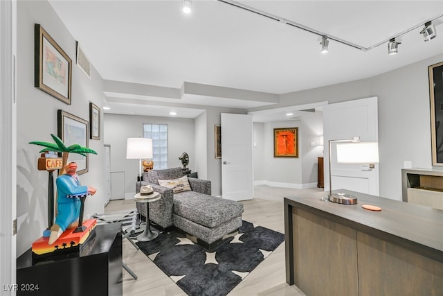 living room featuring light hardwood / wood-style flooring and track lighting