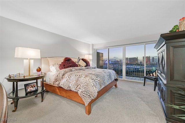 bedroom with access to exterior and light colored carpet