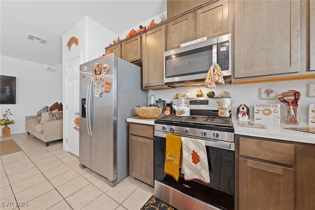 kitchen with appliances with stainless steel finishes and light tile patterned flooring