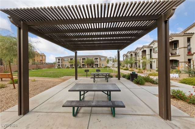 view of home's community with a patio area, a lawn, and a pergola