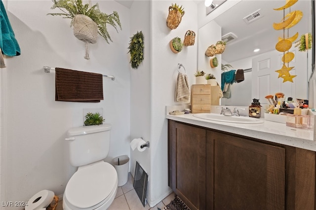 bathroom with vanity, toilet, and tile patterned flooring