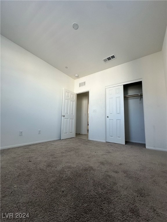 unfurnished bedroom with a closet and carpet floors