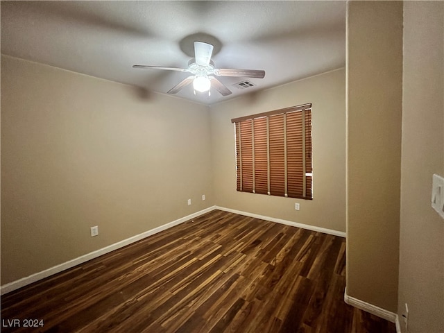 empty room featuring dark hardwood / wood-style floors and ceiling fan