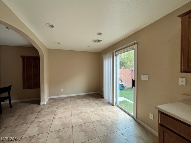 unfurnished dining area featuring light tile patterned flooring